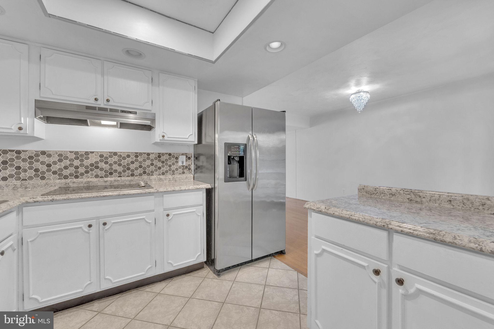 40 Rittenhouse Drive Willingboro, NJ 08046 - Photo 18 of 30 a kitchen with white cabinets appliances and a counter top