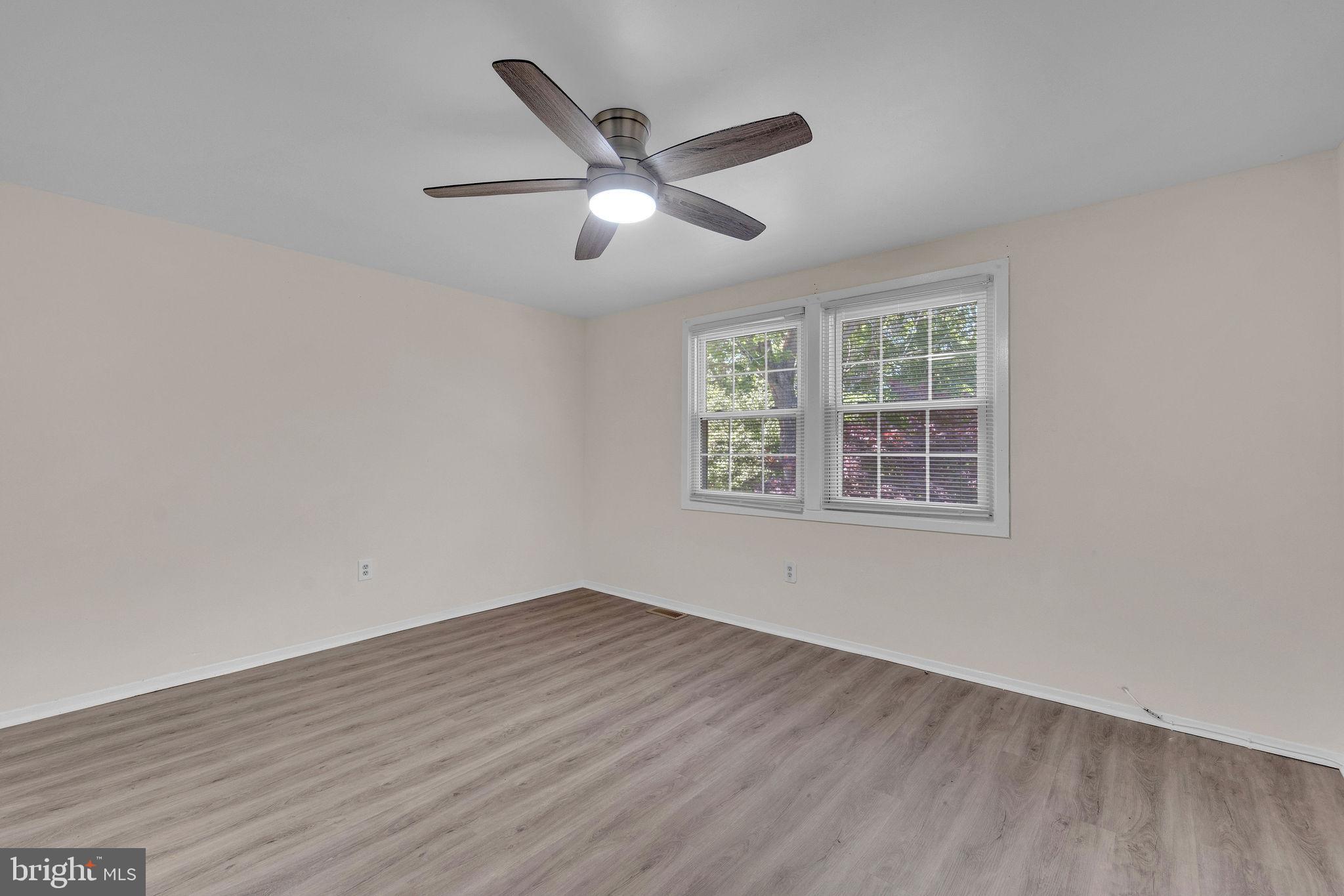 40 Rittenhouse Drive Willingboro, NJ 08046 - Photo 27 of 30 an empty room with wooden floor ceiling fan and windows