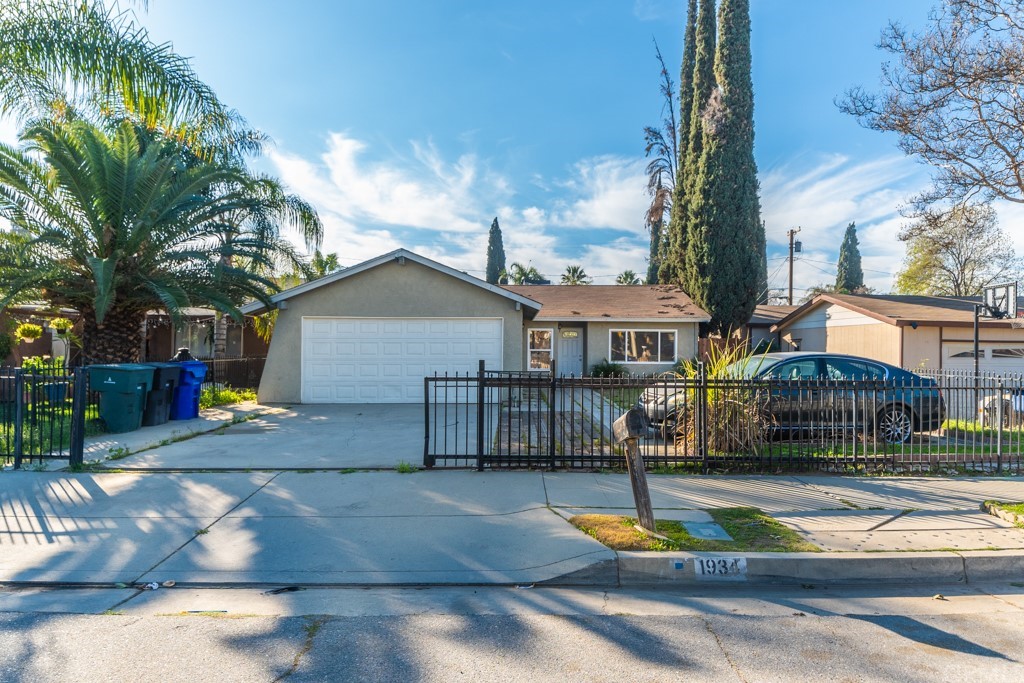 1934 Spring Garden Street Riverside, CA 92507 - Photo 1 of 1 a view of a house with a small yard and large trees
