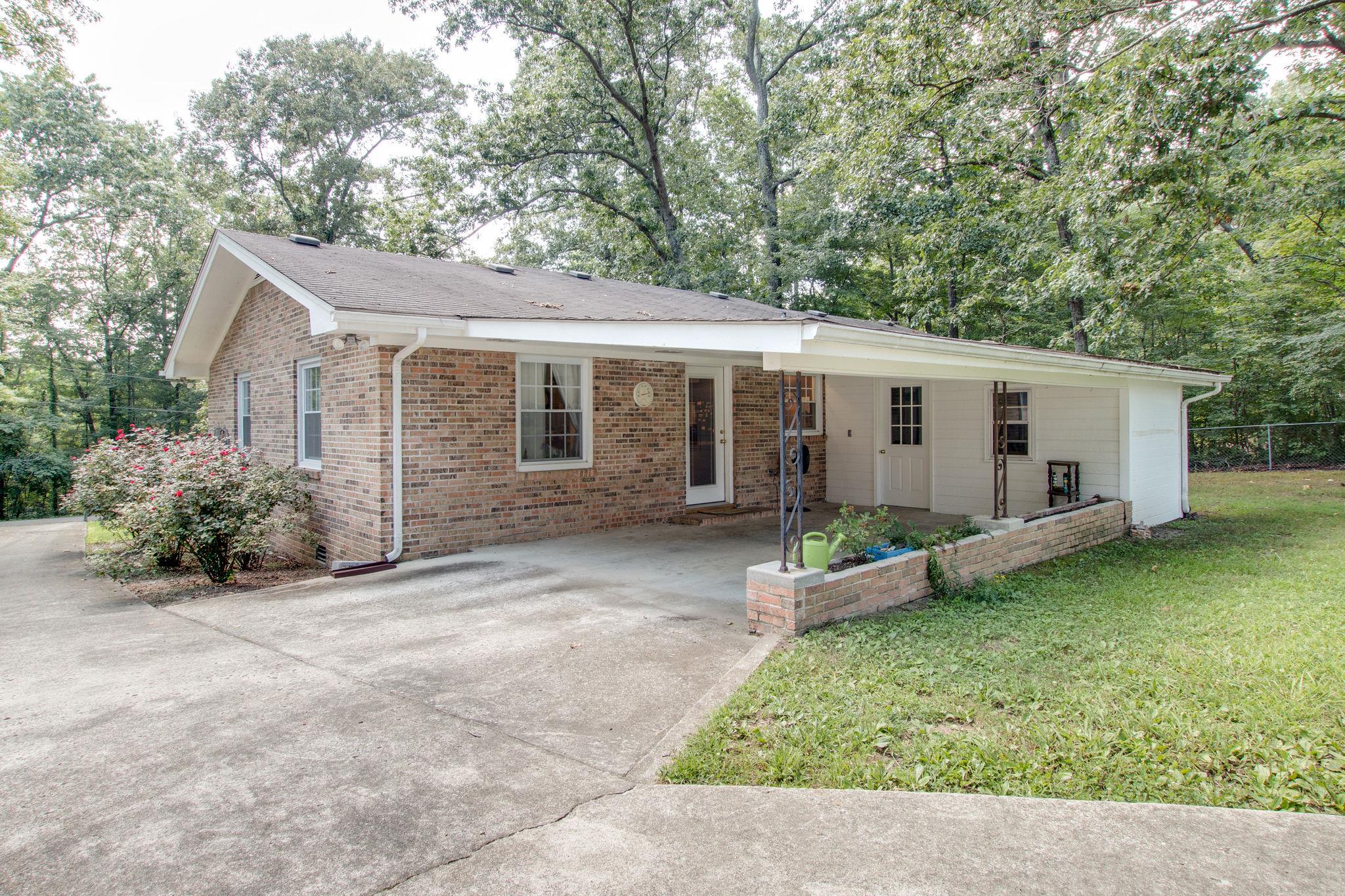 111 West Toliver Road Manchester, TN 37355 - Photo 18 of 19 carpot with seating area and extra storage with electricity