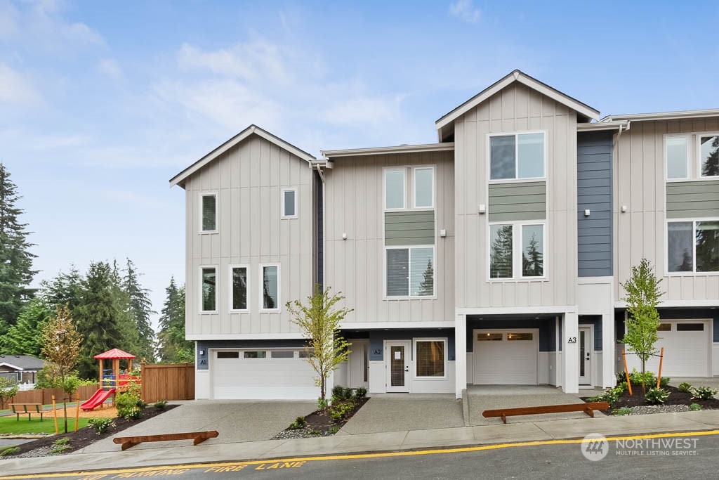 19524 16th Avenue Southeast, Unit B5 Bothell, WA 98012 - Photo 1 of 20 a view of a house with a yard and garage