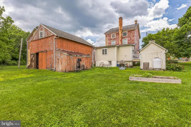 a front view of a house with a garden and yard