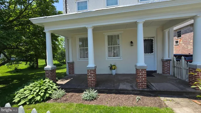 a kitchen with stainless steel appliances granite countertop wooden cabinets a dining table and chairs