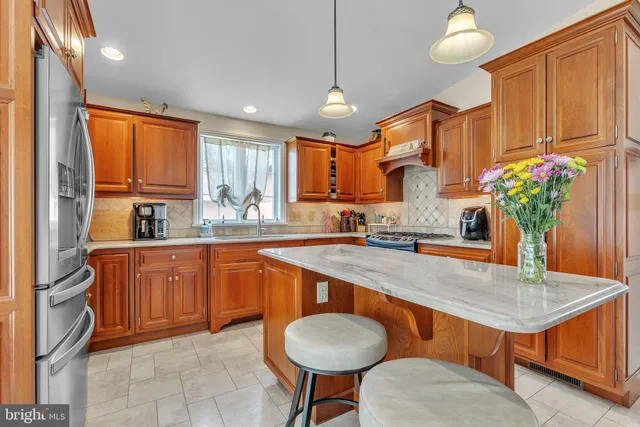 a view of a dining room with furniture and a chandelier