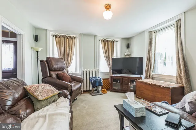 a bedroom with a bed couch and a window