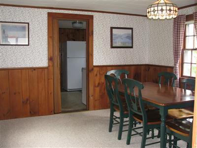 29 Bain Road Dennis Port, MA 02639 - Photo 16 of 21 a view of a dining room with furniture and chandelier