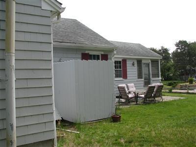 29 Bain Road Dennis Port, MA 02639 - Photo 4 of 21 a view of a house with backyard sitting area and garden