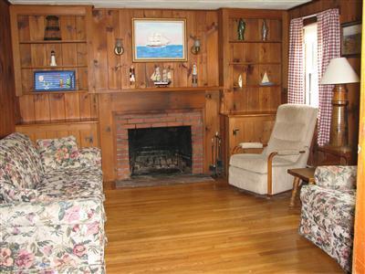 29 Bain Road Dennis Port, MA 02639 - Photo 7 of 21 a living room with furniture and a fireplace