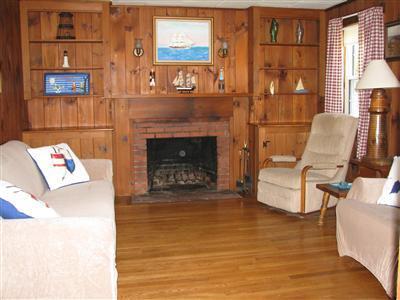 29 Bain Road Dennis Port, MA 02639 - Photo 8 of 21 a living room with furniture and a fireplace