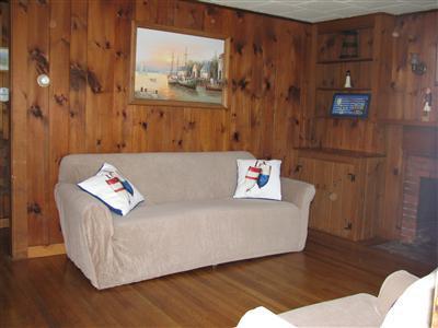 29 Bain Road Dennis Port, MA 02639 - Photo 9 of 21 a living room with a couch and a table with wooden floor