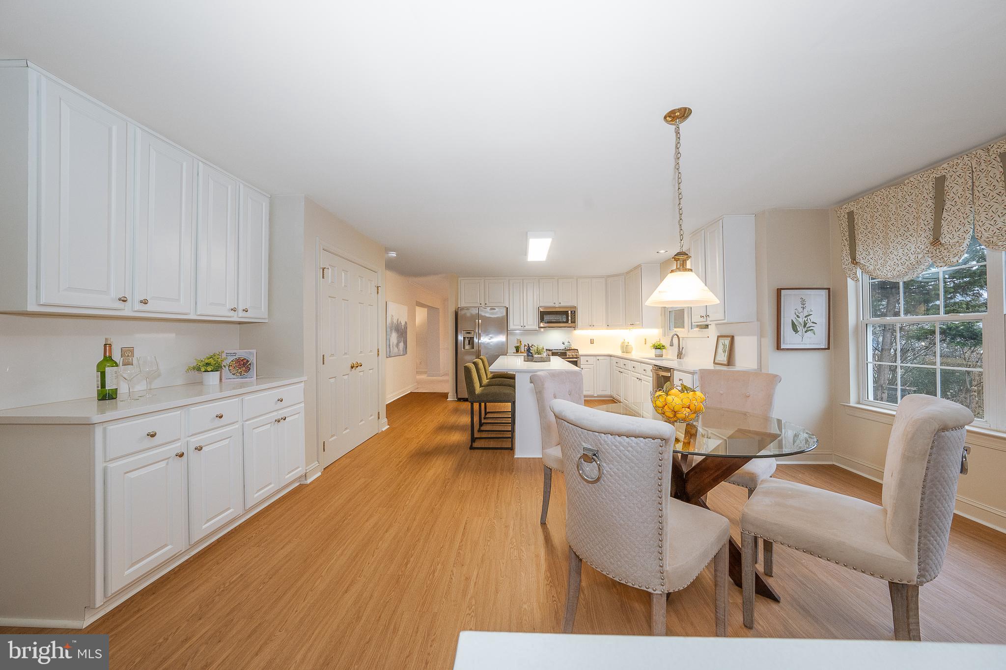 824 Waverly Road Kennett Square, PA 19348 - Photo 12 of 42 a living room with furniture a rug kitchen view and a chandelier