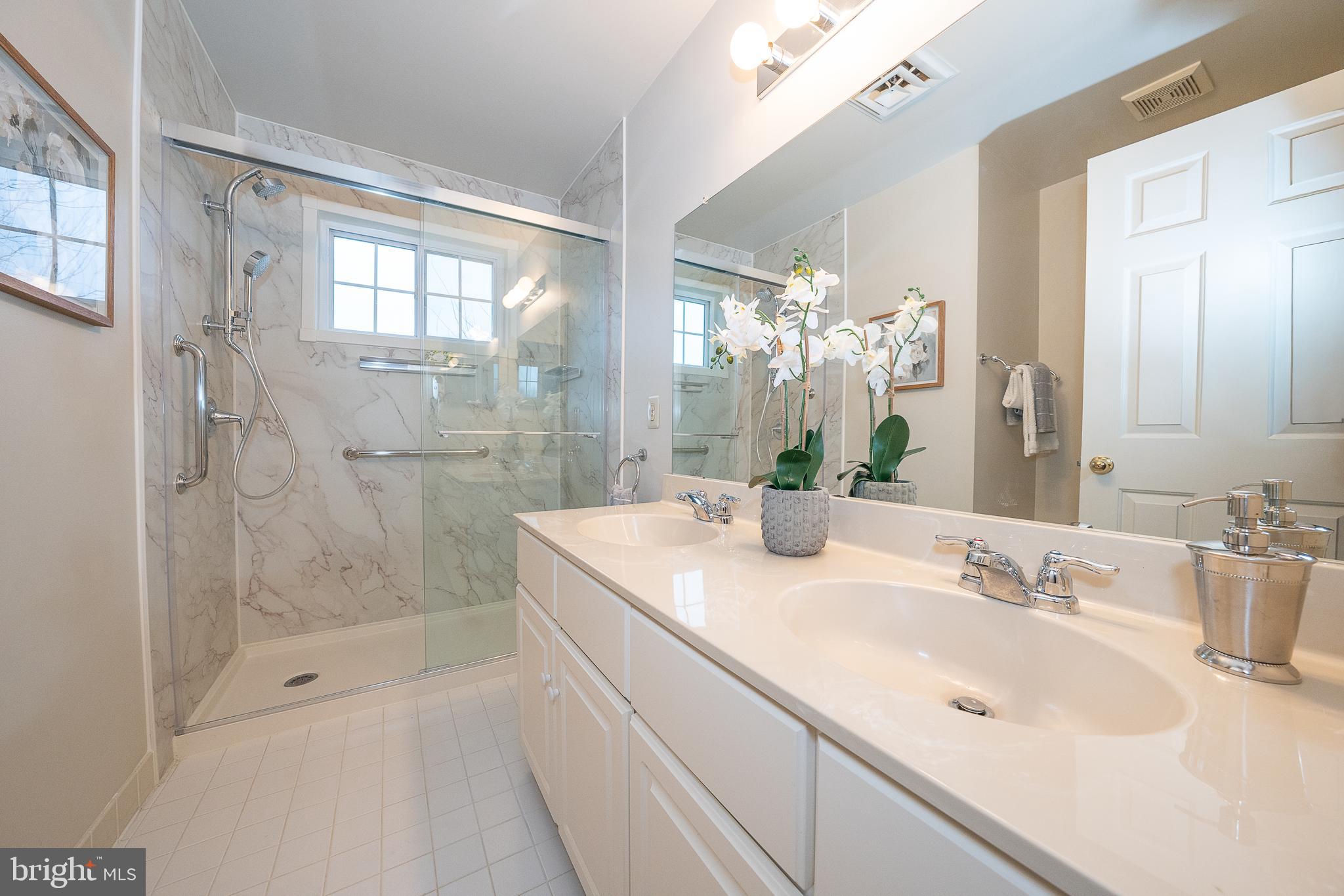 824 Waverly Road Kennett Square, PA 19348 - Photo 32 of 42 a bathroom with a granite countertop sink a mirror and a bathtub