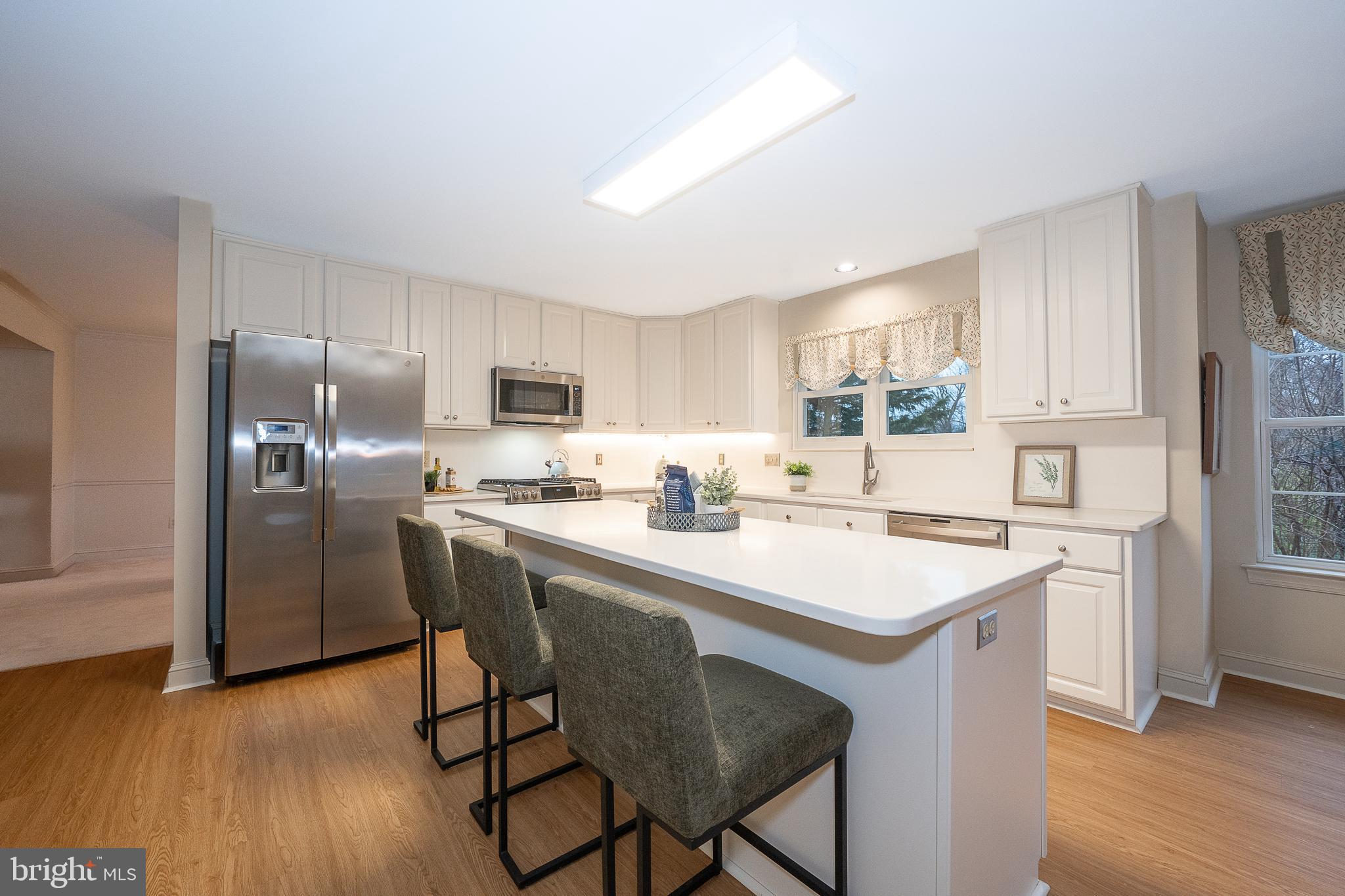 824 Waverly Road Kennett Square, PA 19348 - Photo 10 of 42 a kitchen with stainless steel appliances a sink a stove a refrigerator cabinets and wooden floor