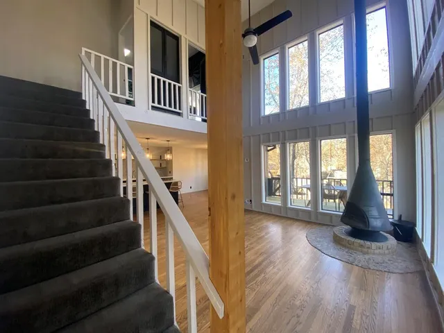 a view of an entryway with wooden floor and staircase