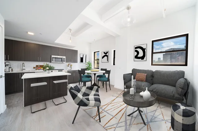 a living room with furniture kitchen view and a flat screen tv