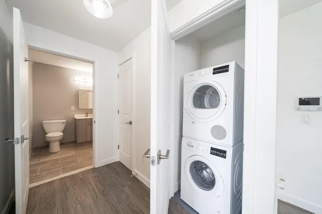 a view of a bedroom with washer and dryer