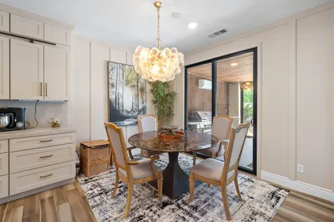 a large kitchen with sink a counter top space and living room view