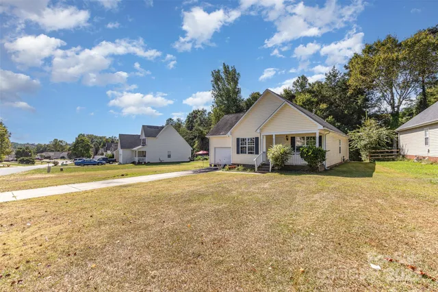 a front view of house with yard and lake view