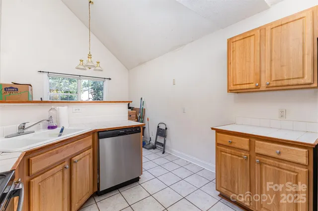 a kitchen with stainless steel appliances granite countertop a sink and cabinets