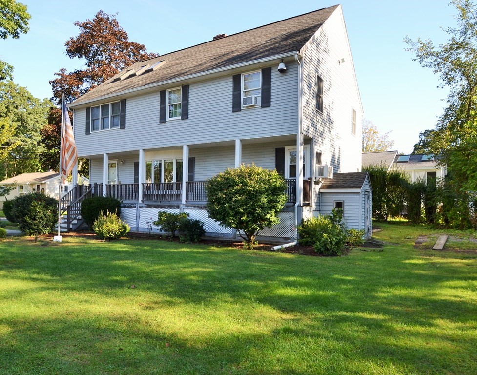 a view of a brick house with a yard