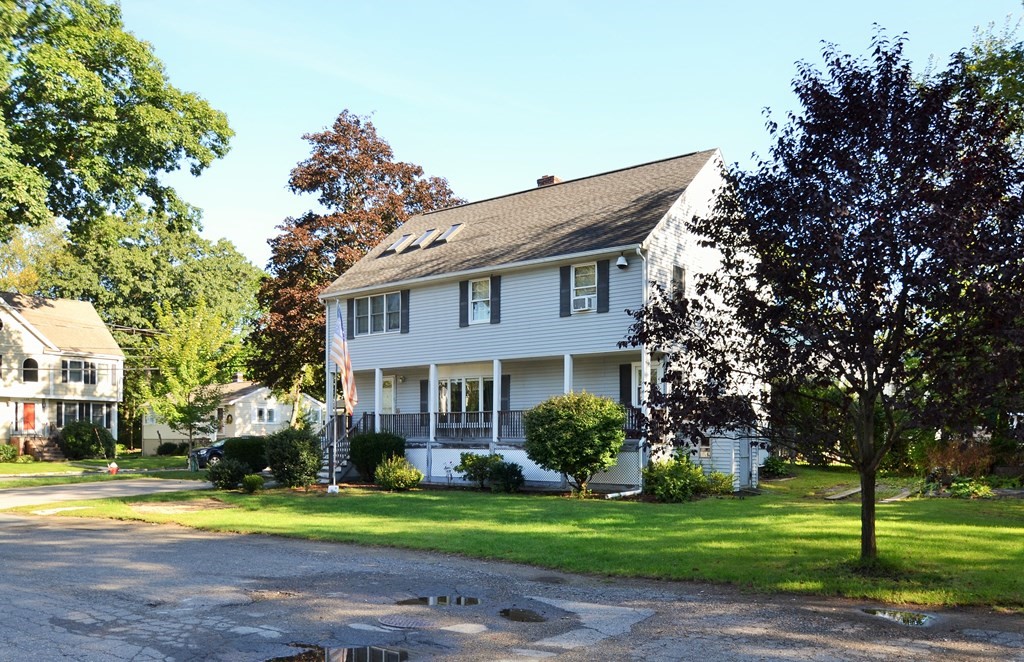 101 Wright Street Arlington, MA 02474 - Photo 2 of 18 a front view of a house with a garden and trees
