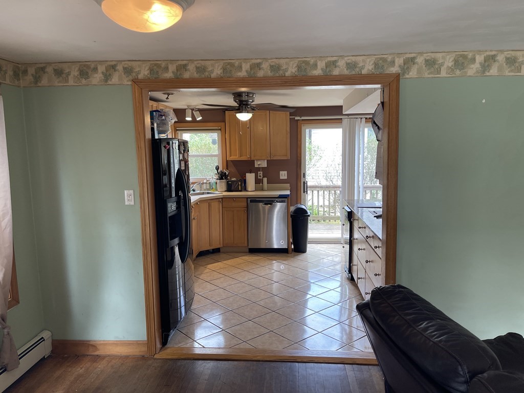 101 Wright Street Arlington, MA 02474 - Photo 7 of 18 a living room with stainless steel appliances granite countertop furniture and a fireplace