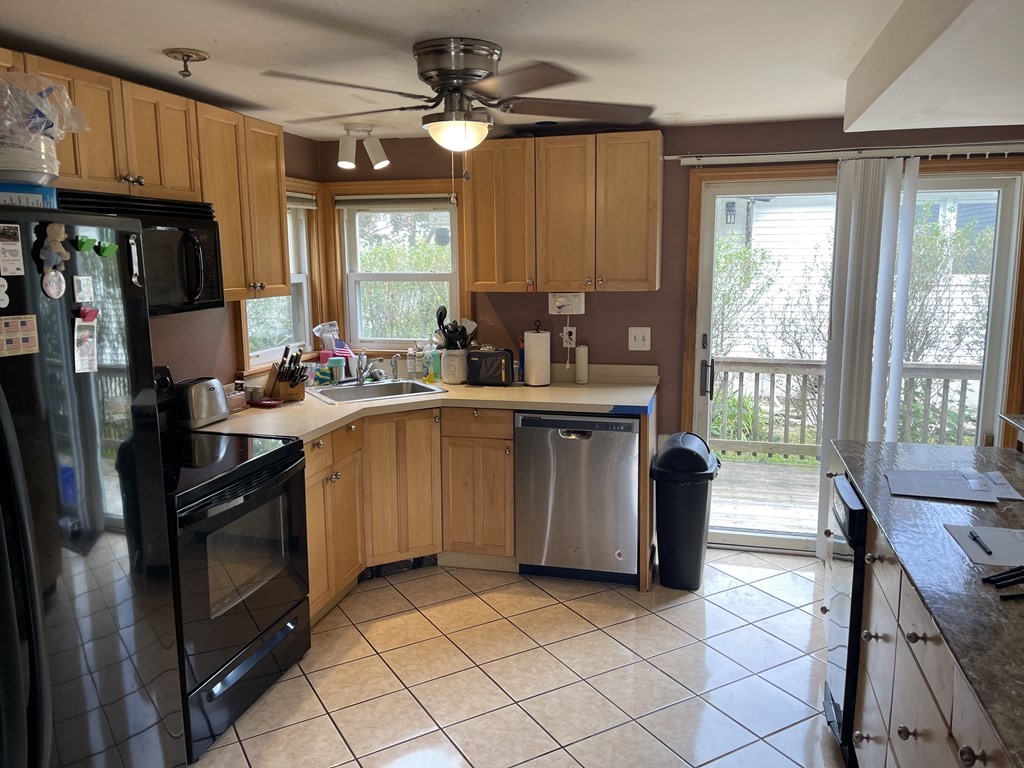 101 Wright Street Arlington, MA 02474 - Photo 8 of 18 a kitchen with a sink a stove a refrigerator and furniture