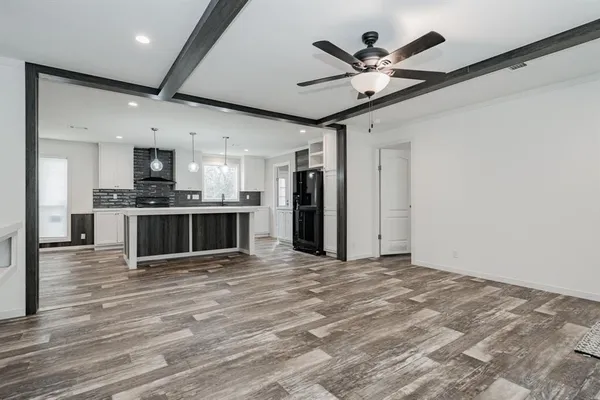 a view of kitchen with sink microwave and refrigerator