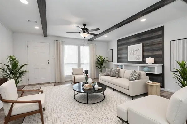 a living room with furniture potted plant and a window