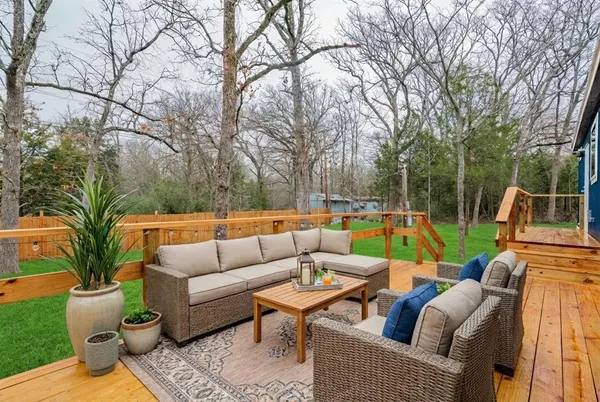 a view of a patio with couches chairs and a fire pit