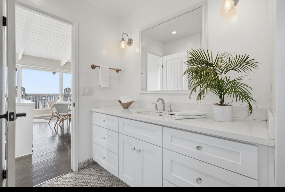 229 Rio Del Mar Boulevard Aptos, CA 95003 - Photo 21 of 27 a bathroom with a sink a mirror and a potted plant