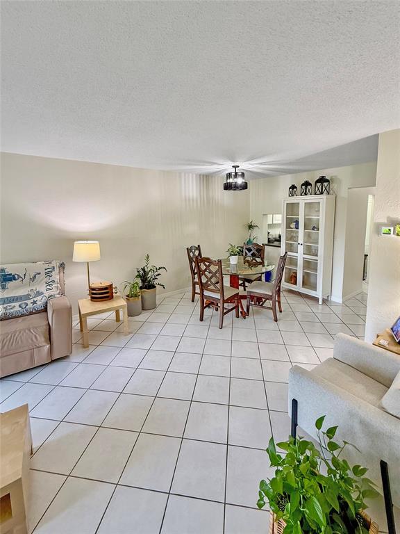 2350 Northeast 14th Street Causeway, Unit 108 Pompano Beach, FL 33062 - Photo 11 of 38 a living room with furniture and a potted plant
