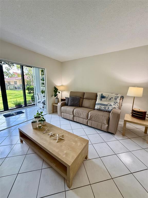 2350 Northeast 14th Street Causeway, Unit 108 Pompano Beach, FL 33062 - Photo 12 of 38 a living room with furniture and large windows