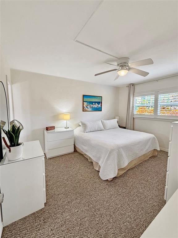 2350 Northeast 14th Street Causeway, Unit 108 Pompano Beach, FL 33062 - Photo 18 of 38 a spacious bedroom with a bed and a couch