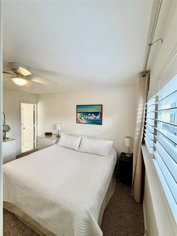 2350 Northeast 14th Street Causeway, Unit 108 Pompano Beach, FL 33062 - Photo 19 of 38 a bedroom with a bed and a walk in closet