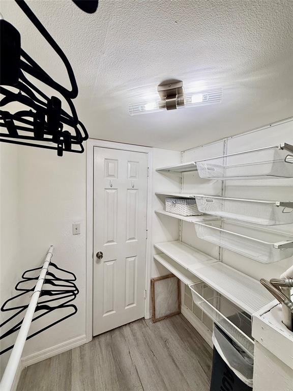 2350 Northeast 14th Street Causeway, Unit 108 Pompano Beach, FL 33062 - Photo 20 of 38 walk in closet with wooden floor