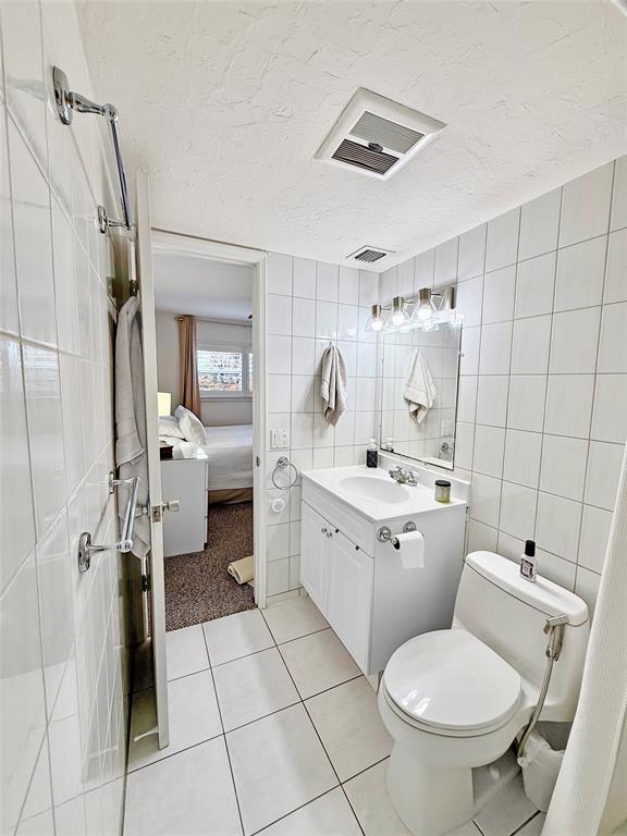 2350 Northeast 14th Street Causeway, Unit 108 Pompano Beach, FL 33062 - Photo 23 of 38 a bathroom with a toilet sink and mirror