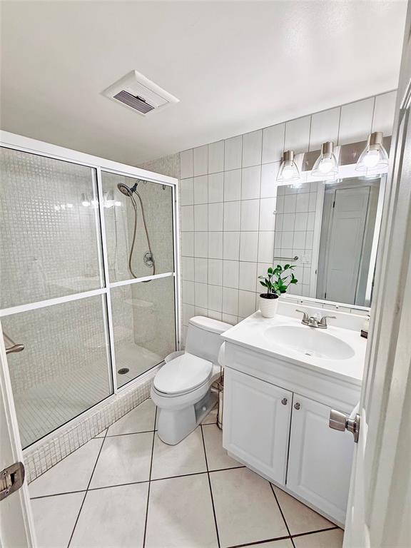 2350 Northeast 14th Street Causeway, Unit 108 Pompano Beach, FL 33062 - Photo 26 of 38 a bathroom with a sink toilet and shower