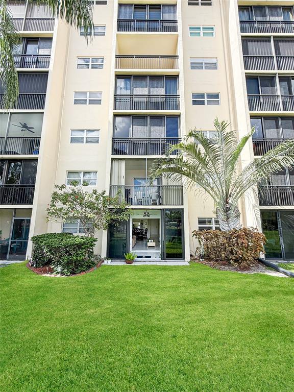 2350 Northeast 14th Street Causeway, Unit 108 Pompano Beach, FL 33062 - Photo 34 of 38 a front view of a building with a garden
