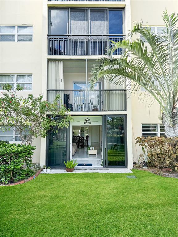 2350 Northeast 14th Street Causeway, Unit 108 Pompano Beach, FL 33062 - Photo 35 of 38 a front view of building with yard