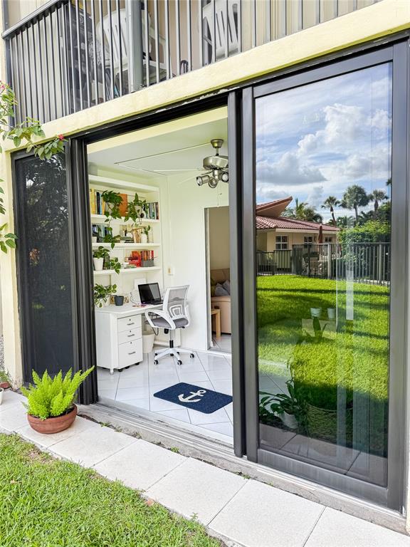 2350 Northeast 14th Street Causeway, Unit 108 Pompano Beach, FL 33062 - Photo 37 of 38 a view of a porch with chairs and floor to ceiling window