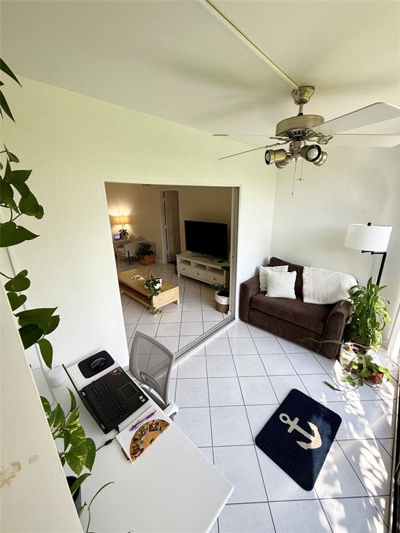 2350 Northeast 14th Street Causeway, Unit 108 Pompano Beach, FL 33062 - Photo 4 of 38 a living room with furniture and a flat screen tv