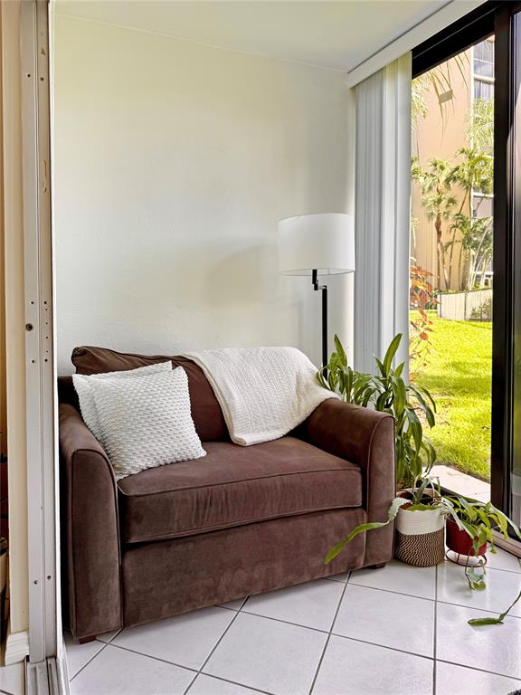 2350 Northeast 14th Street Causeway, Unit 108 Pompano Beach, FL 33062 - Photo 9 of 38 a living room with a couch and a flat screen tv