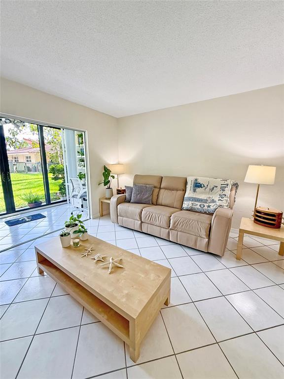 2350 Northeast 14th Street Causeway, Unit 108 Pompano Beach, FL 33062 - Photo 10 of 38 a living room with furniture and large window