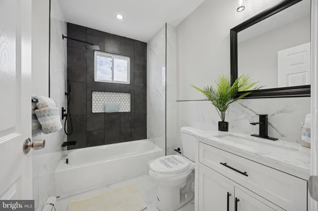 a bathroom with a sink a toilet and a bathtub