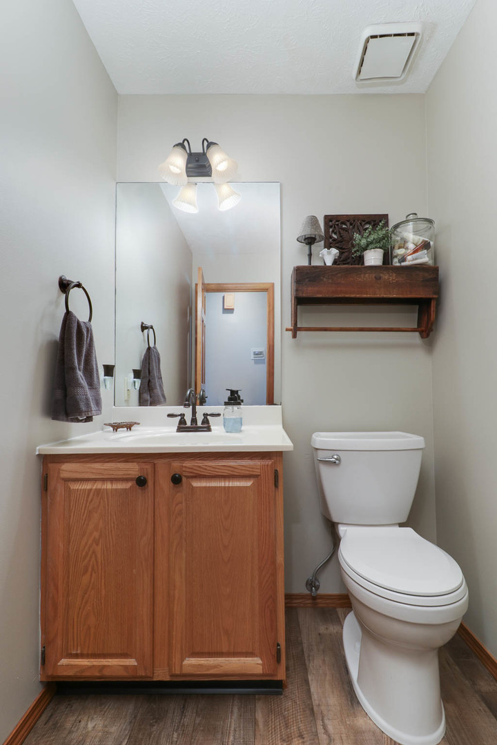 3203 Eagle Crest Road Bloomington, IL 61704 - Photo 15 of 52 a bathroom with a toilet a sink and mirror