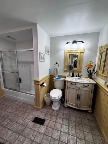 a bathroom with a glass shower door and a bathtub