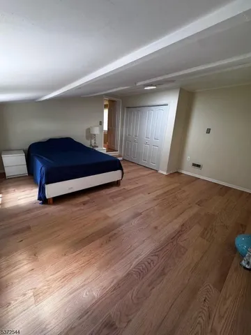 a room with wooden floors and pool table