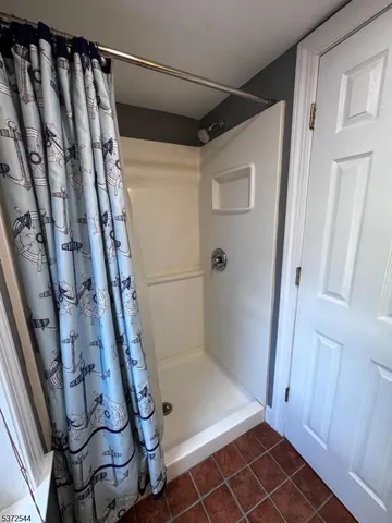 a bathroom with a toilet a sink and a window