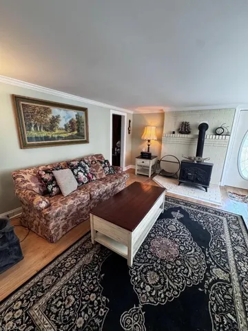 a living room with furniture rug and window